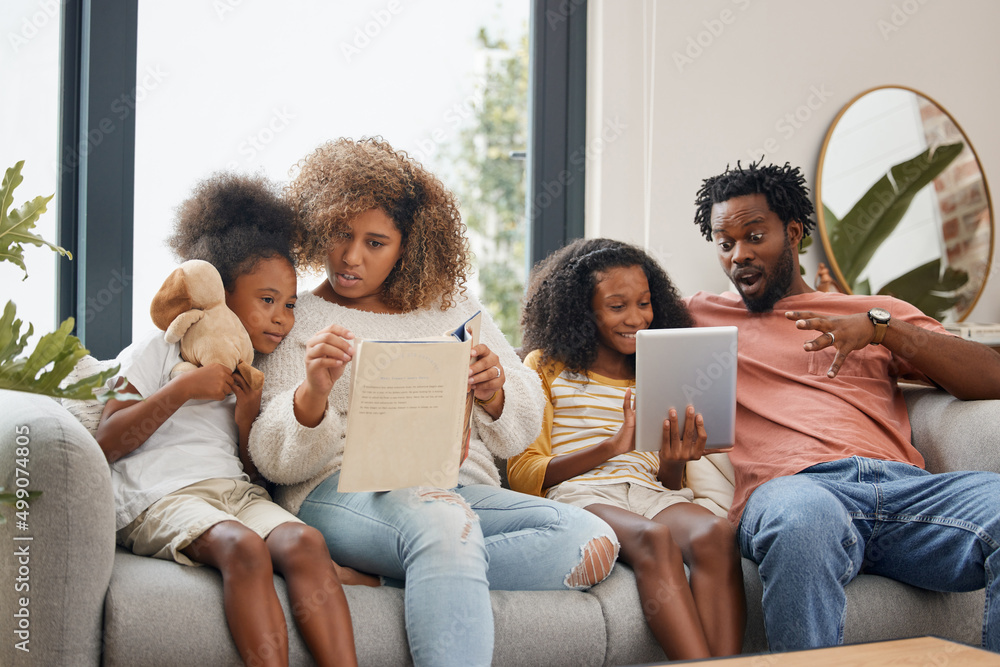 Learning can occur in two different ways. Shot of a young family spending time together and using a 