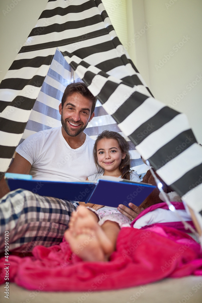 Theres nothing more important than quality time together. Portrait of a father reading a book with h