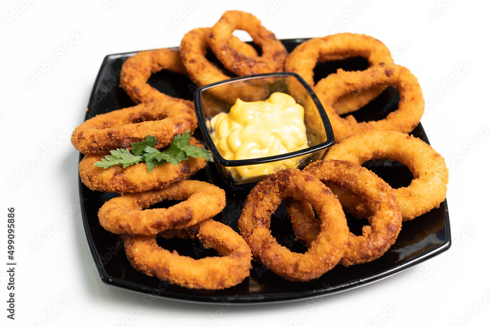 onion rings, dark plate, white background, sauce