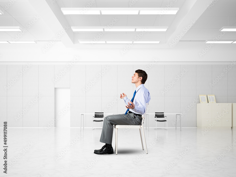 young businessman meditating in the office