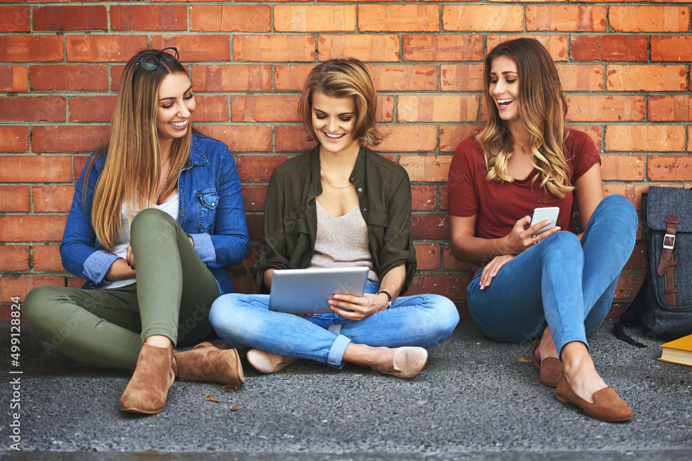 Wifi lets them study anywhere on campus. Shot of three smiling female university students sitting to