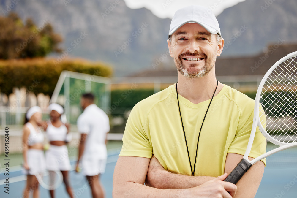 I give my students only the best. Cropped portrait of a handsome mature male tennis coach standing o