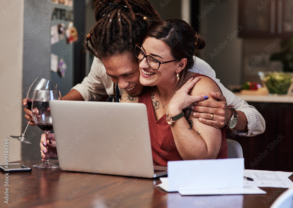 We are happy and enjoying life. Cropped shot of a cheerful young couple having a video call while en