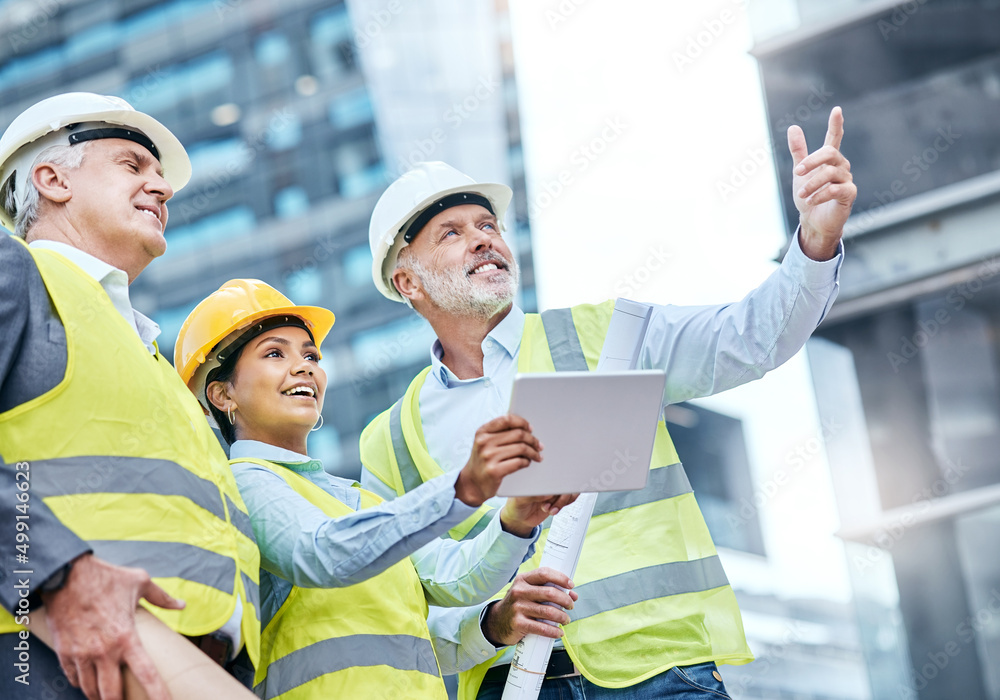 Managing a complex project together. Shot of a group of businesspeople using a digital tablet while 