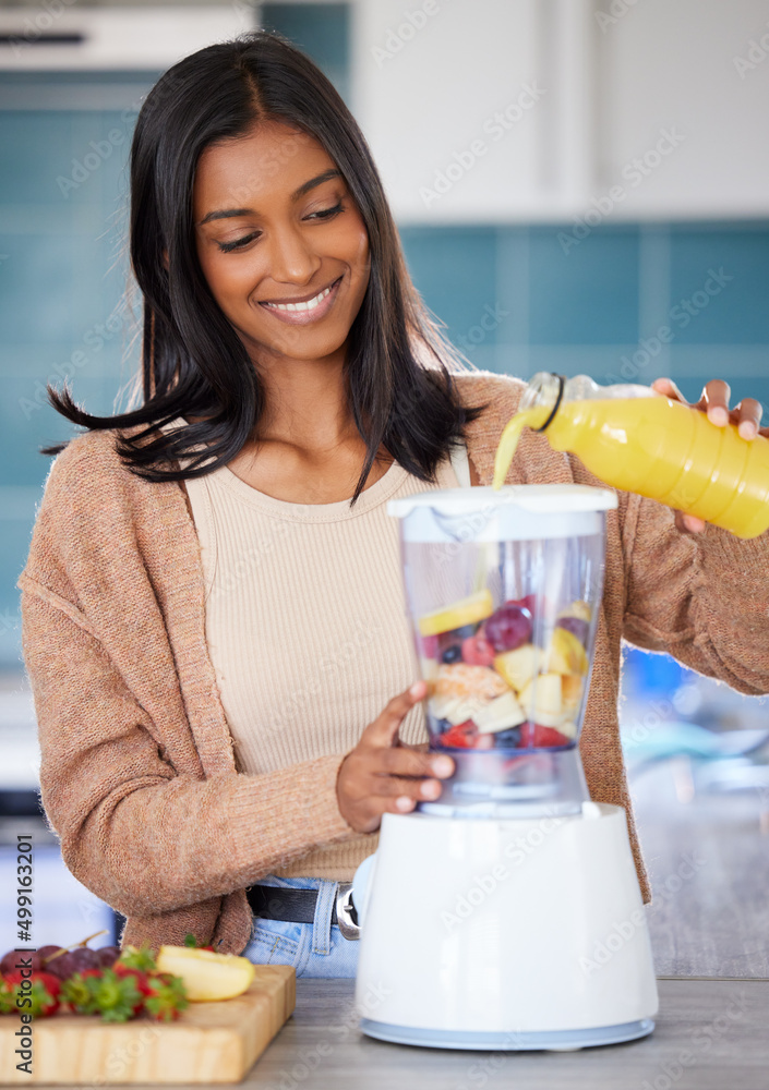 Whipping up a delicious drink in just a few minutes. Shot of a young woman preparing a healthy smoot