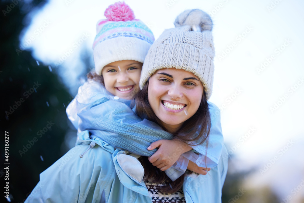 Nothing beats playing in the rain. Shot of an attractive young woman giving her daughter a piggyback