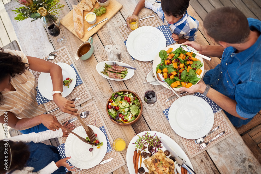 Serving love and happiness with every meal. High angle shot of a young family of four enjoying a mea