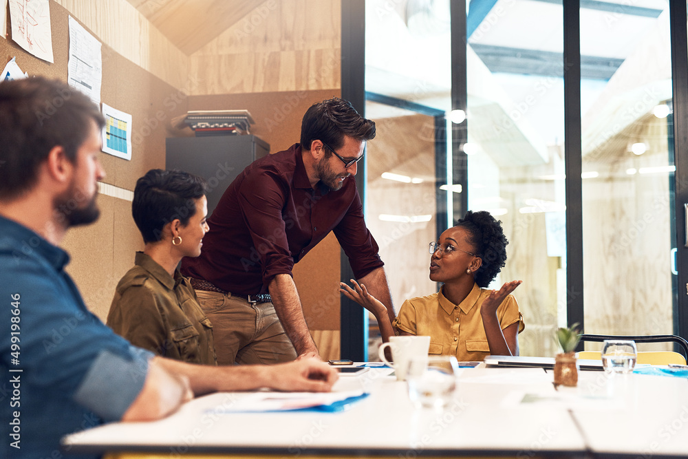 Taking steps to ensure success together. Shot of a diverse group of businesspeople having a meeting 