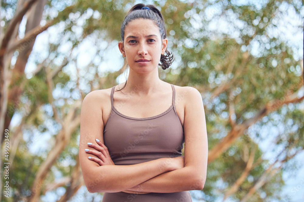 Conquer it all with determination. Portrait of a sporty young woman standing with her arms crossed w