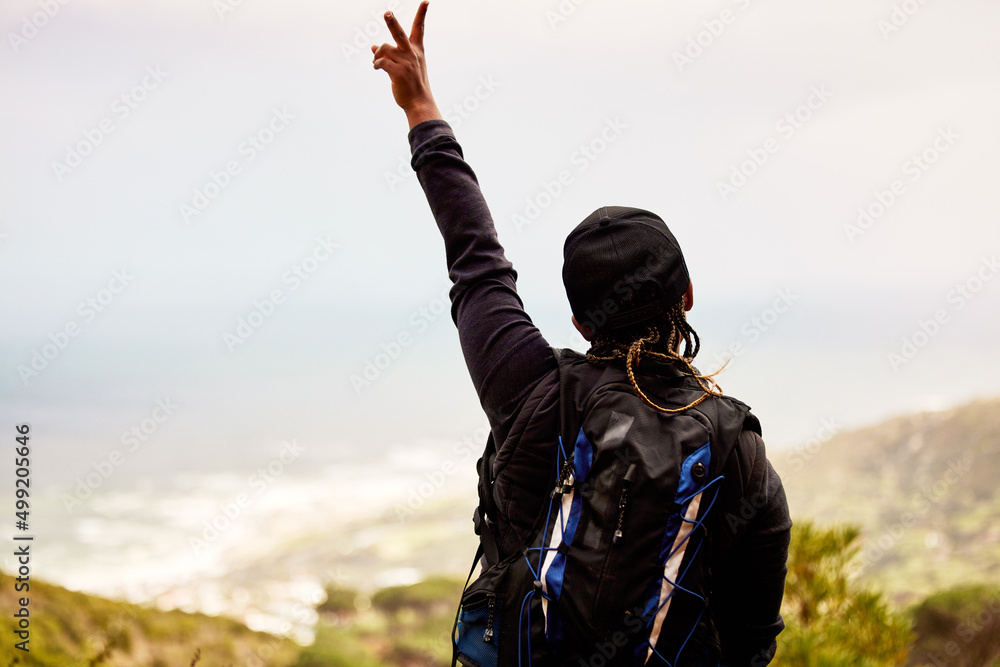 Peace to all the negativity. Shot of an unrecognizable woman enjoying a day in nature.