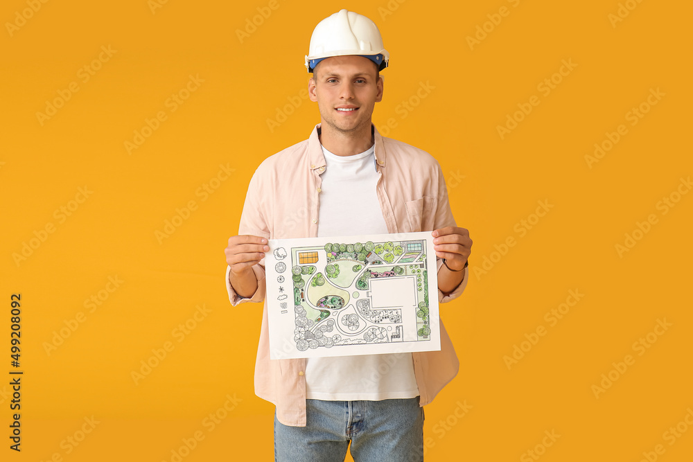 Young male landscape designer with new project on color background