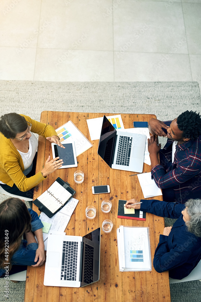 Birds eye view of creative business. High angle shot of a team of creatives meeting around a table w