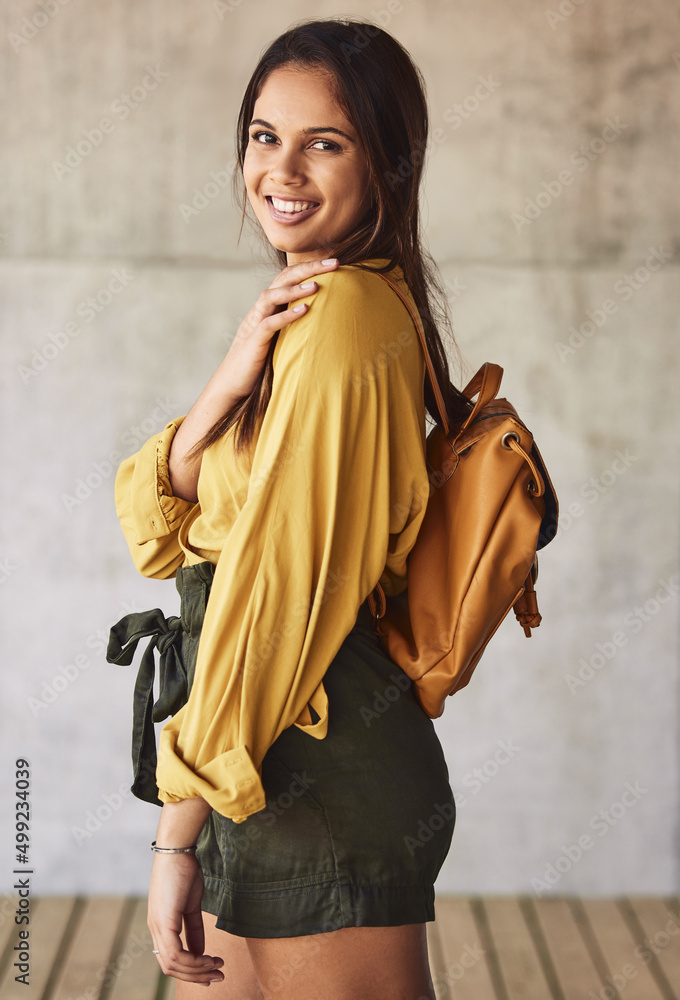 Living in, and for NOW. Portrait of an attractive young woman posing outdoors against an urban backg