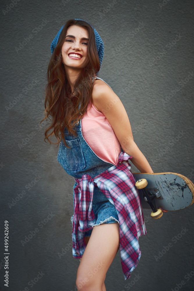 The sweetest skateboarder youll ever meet. Shot of an attractive young female skater holding a skate