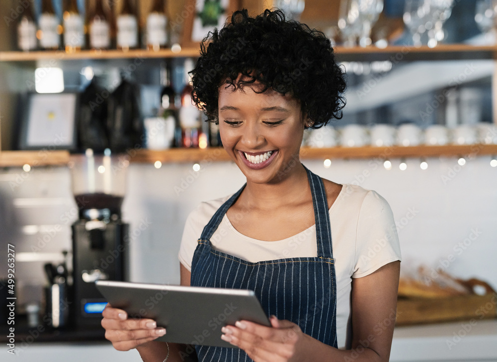 Taking advantage of technological tools to boost sales. Shot of a young woman using a digital tablet