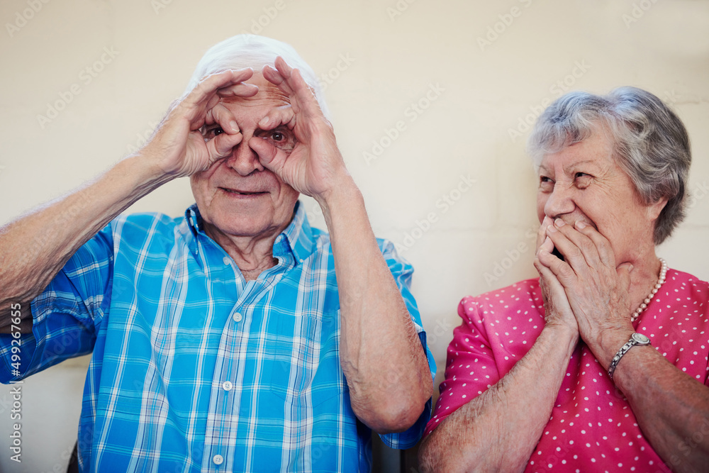 Time brought us so much happiness. Shot of a senior couple making funny faces outside.