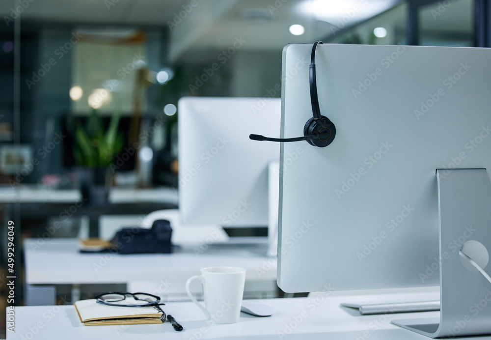 Solving problems one call at a time. Shot of a work station in a call centre.