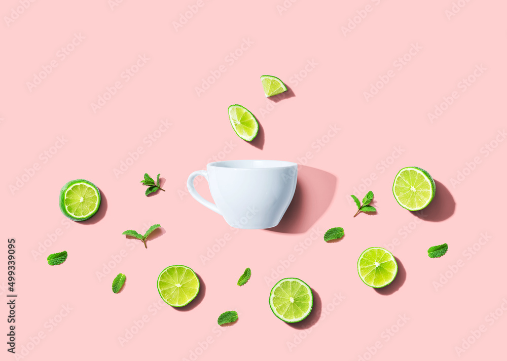 Fresh limes with tea cup overhead view - flat lay