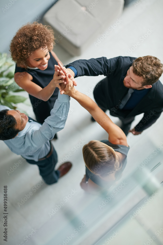 Success is built on teamwork. High angle shot of a group of businesspeople high fiving together in a