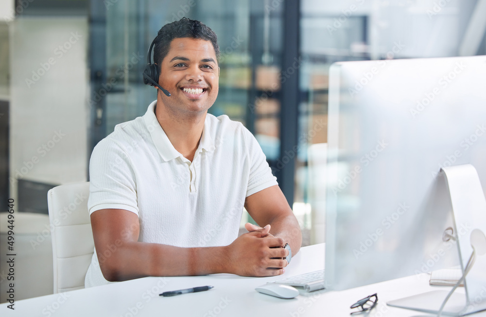 Ready to be of assistance. Shot of a handsome young businessman sitting alone in his office and wear