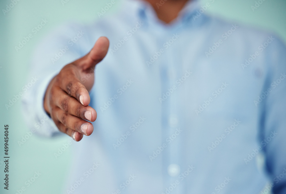 Welcome. Cropped shot of an unrecognizable businessman standing with his hand outstretched for a han