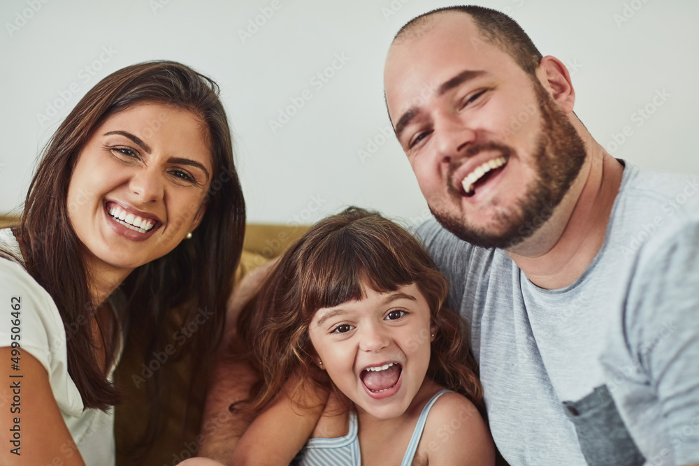 Home, the happiest place there is. Portrait of a mother and father bonding with their adorable young