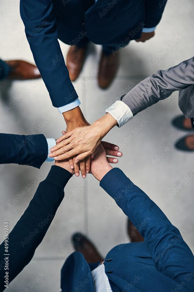 Together is always better. High angle shot of a group of businesspeople joining their hands together