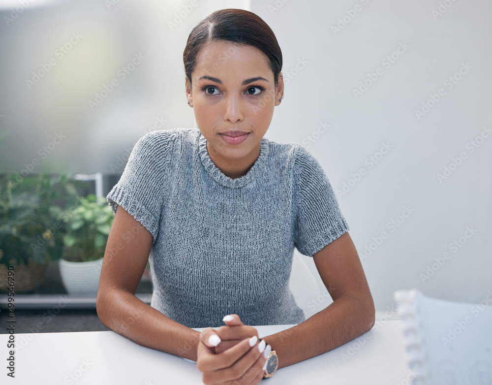 I just need to stay calm. Shot of a young businesswoman sitting in on a meeting in an office.