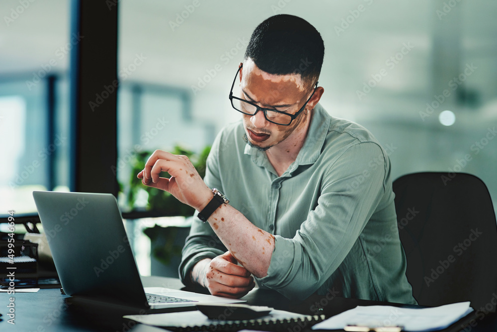 Its time to put in the work for your success. Shot of a young businessman checking the time in an of