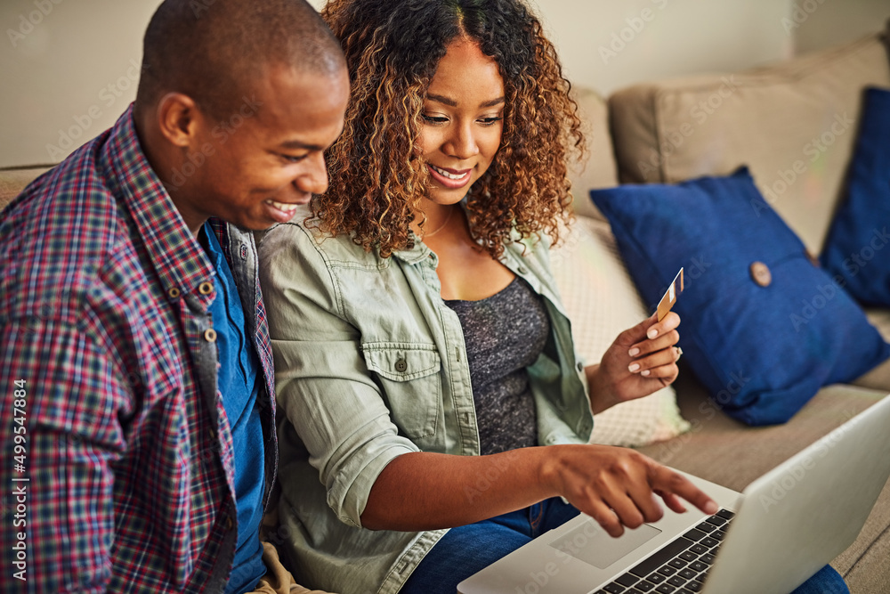 Do you think we should buy this. Shot of a cheerful young couple doing online shopping together whil