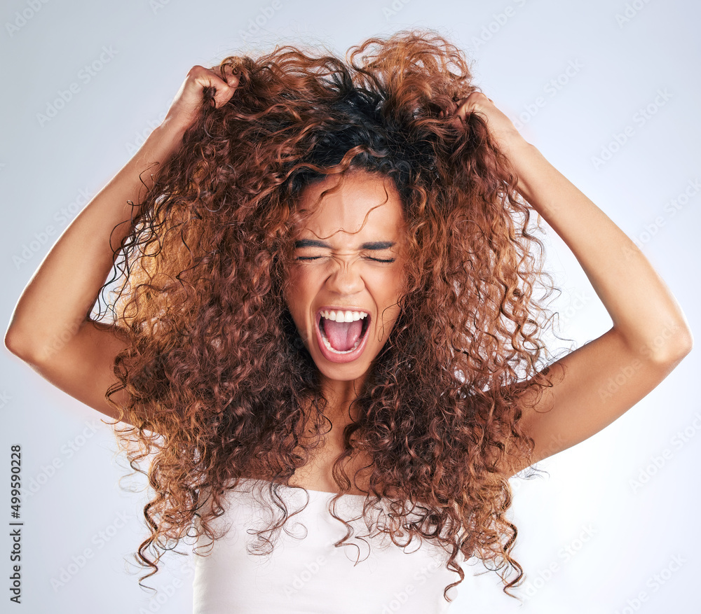 Its driving me crazy. Cropped shot of an attractive young woman looking frustrated in studio against