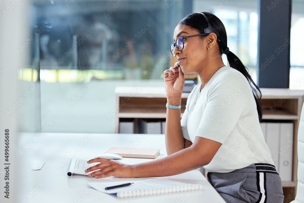 Hello, how can I help you. Shot of an attractive young businesswoman sitting alone in her office and