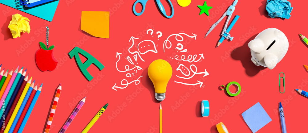 Brainstorming concept with a light bulb and school supplies - Flat lay