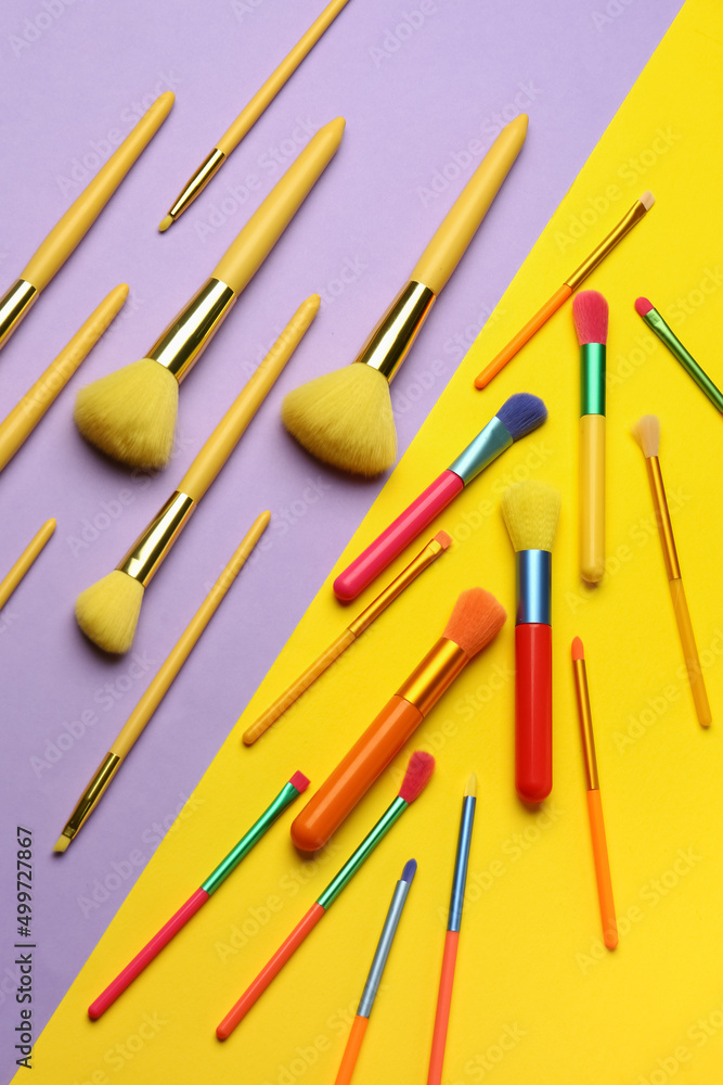 Set of different makeup brushes on color background