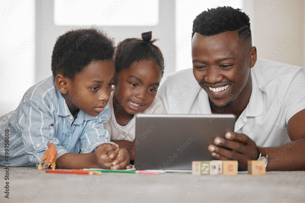 Helping with homework in a fun way. Shot of a father using a digital tablet with his son and daughte