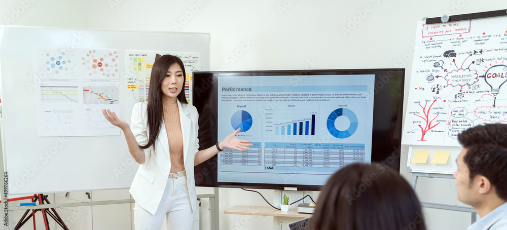 Business woman present graph chart form monitor in office