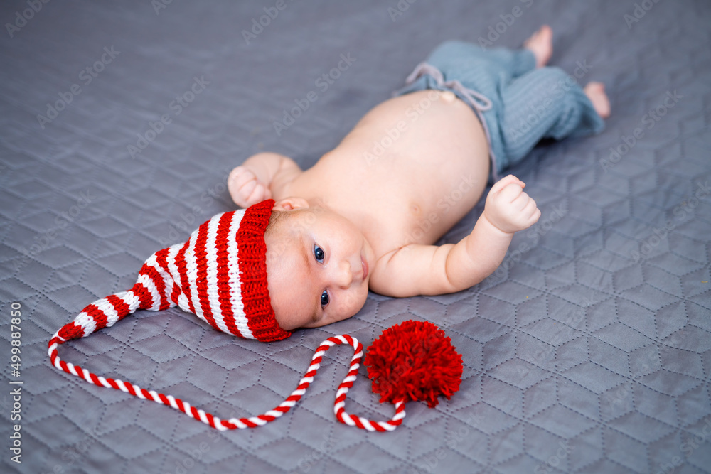 Sweet young infant kid portrait. Cute baby in adorable hat.