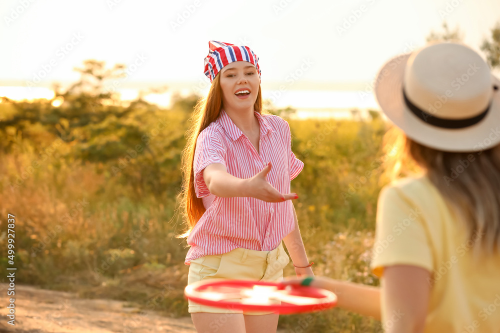 快乐的年轻女子在夏日玩飞盘