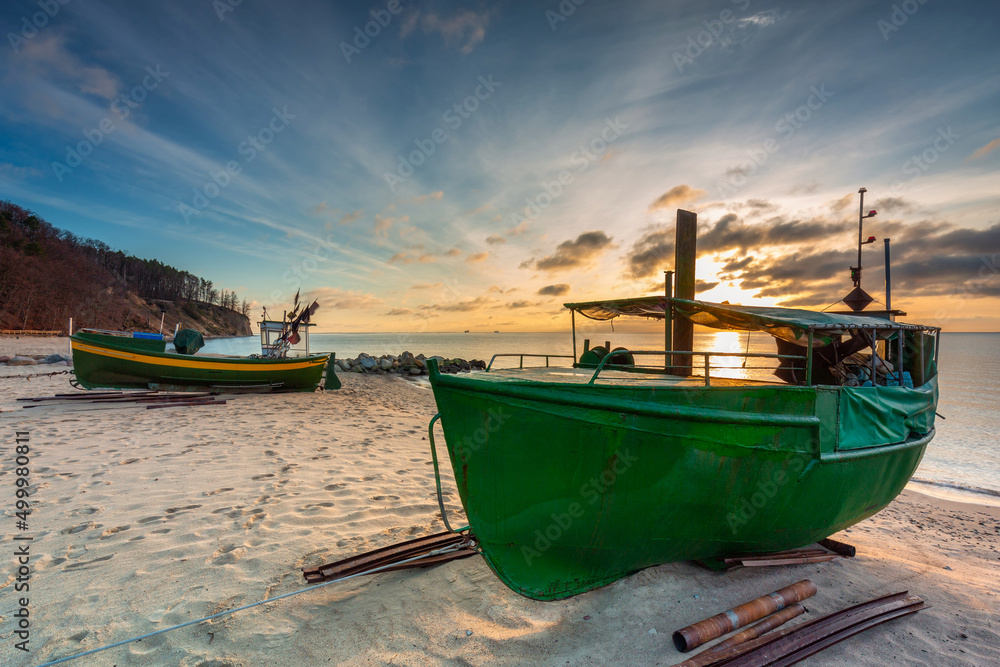 Beautiful landscape of the beach with fishing boats at sunrise in Gdynia Orlowo. Poland