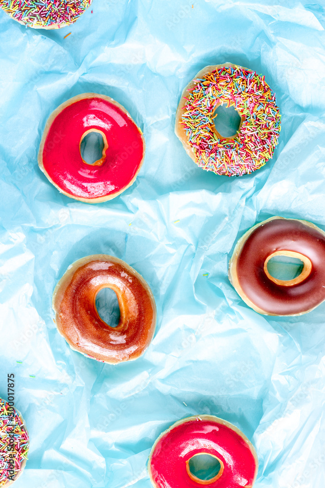 lunch with donuts on blue background top view pattern