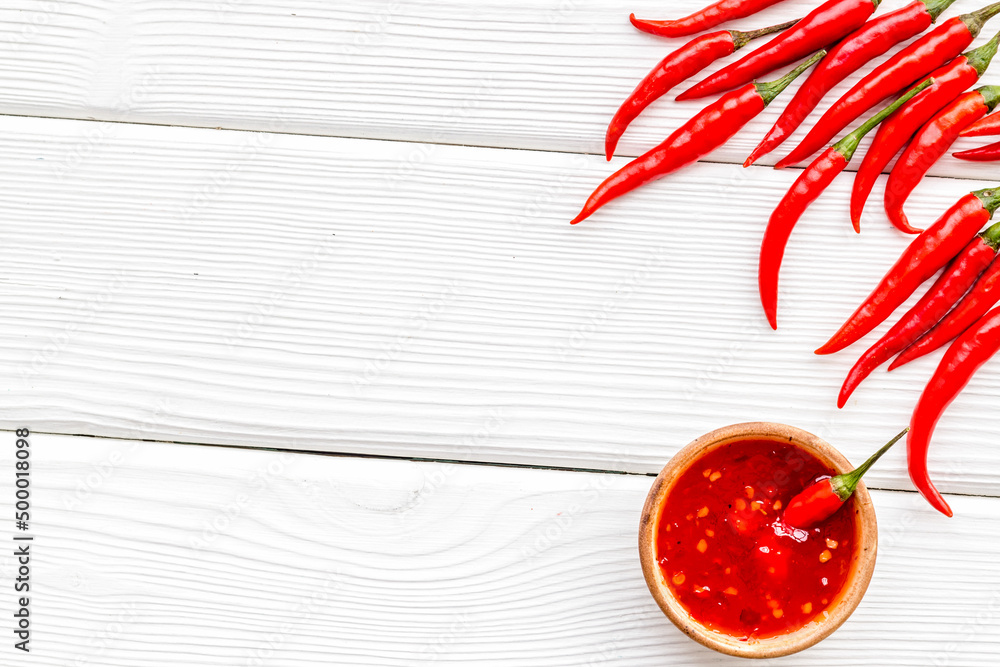 Fresh red chilli pepper pattern on white wooden table background top view space for text