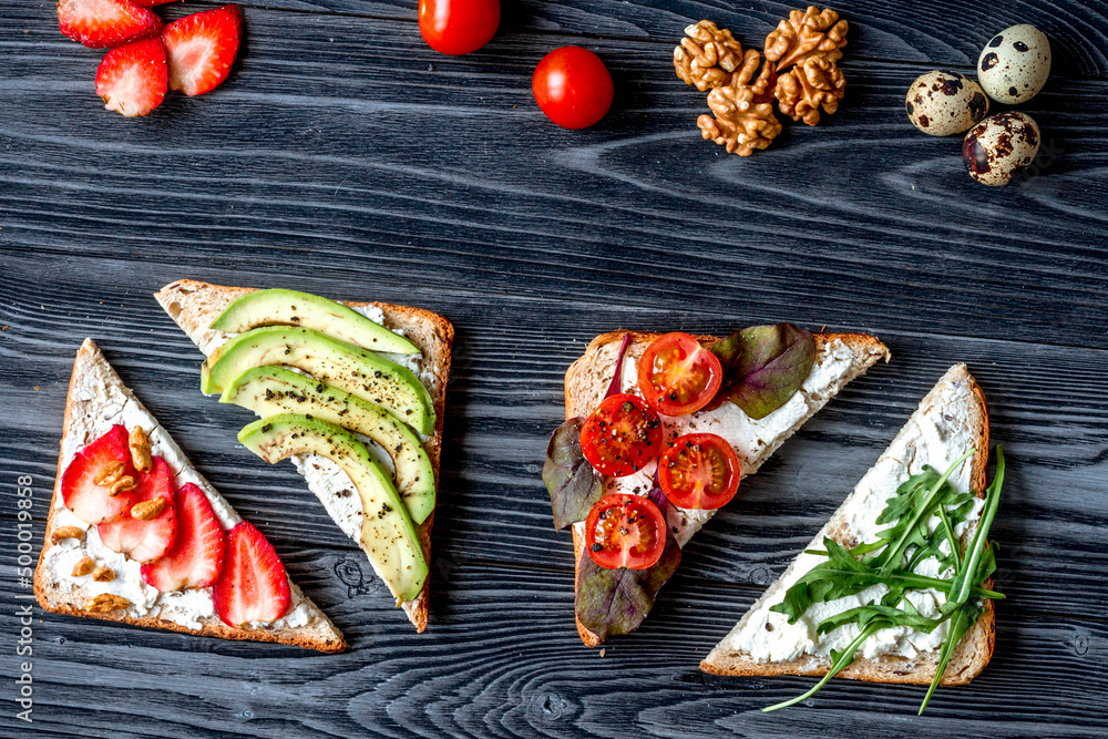 sandwiches set on dark table background top view