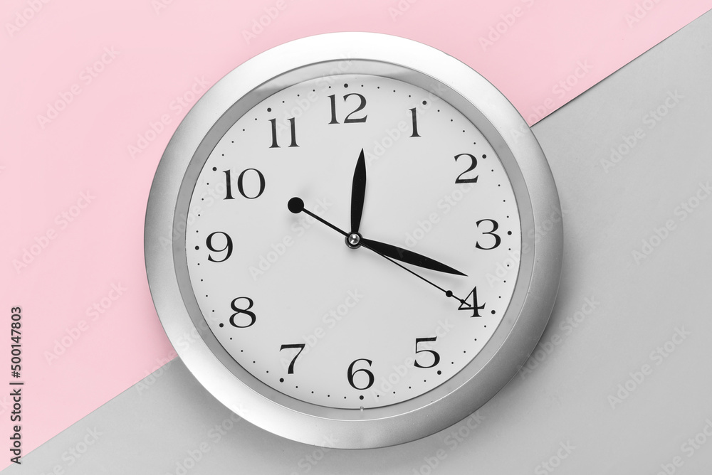 New modern clock on color background