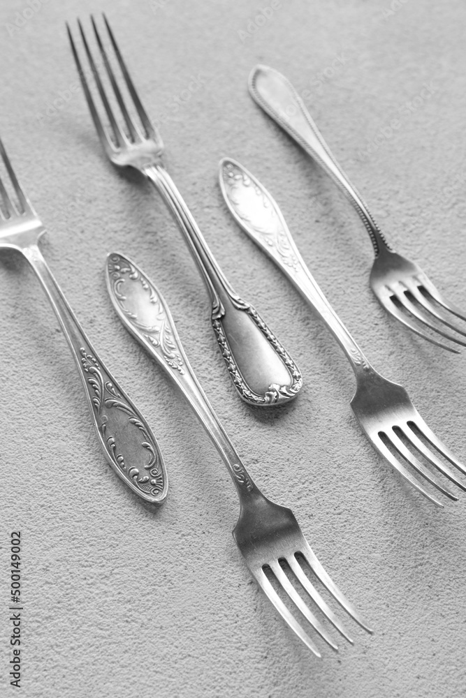 Silver forks on light background