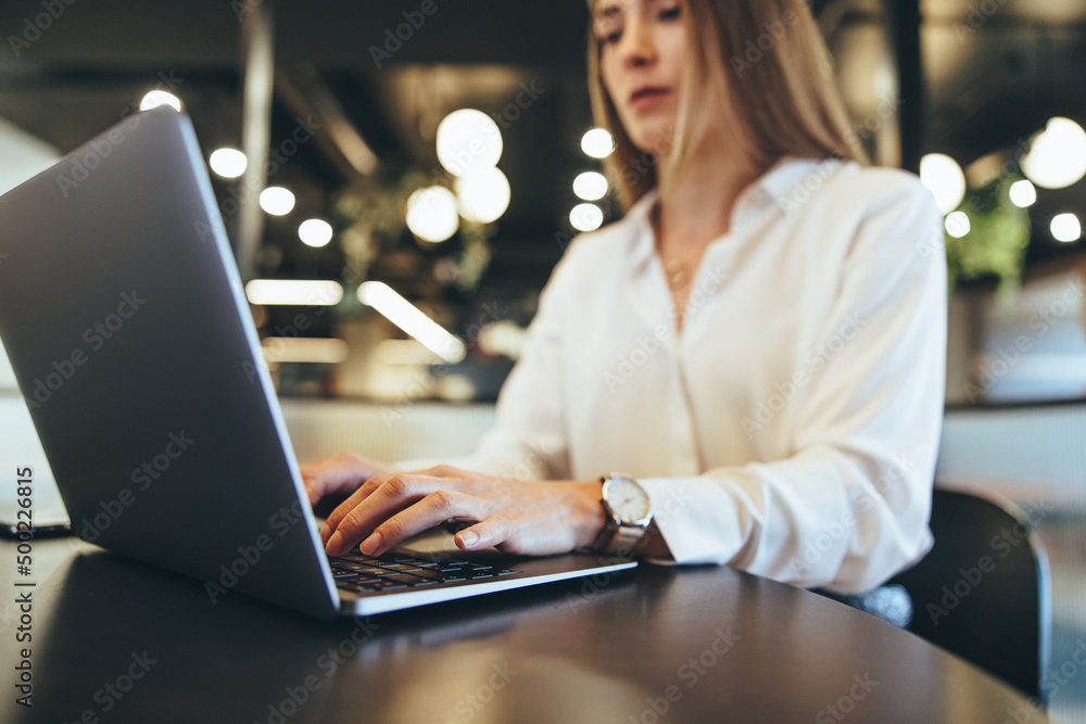 Businesswoman typing on a laptop at work