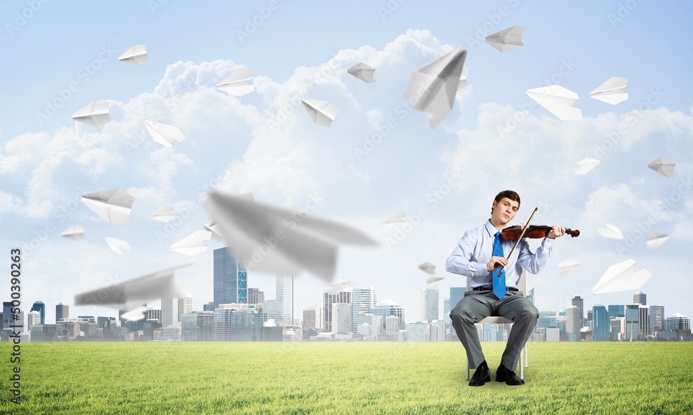 young businessman playing violin