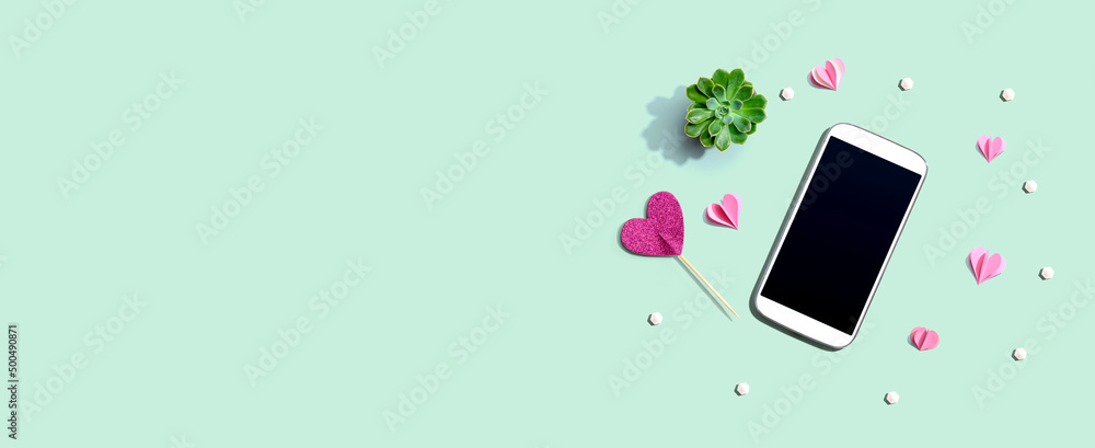 Smartphone with hearts and a succulent - flat lay