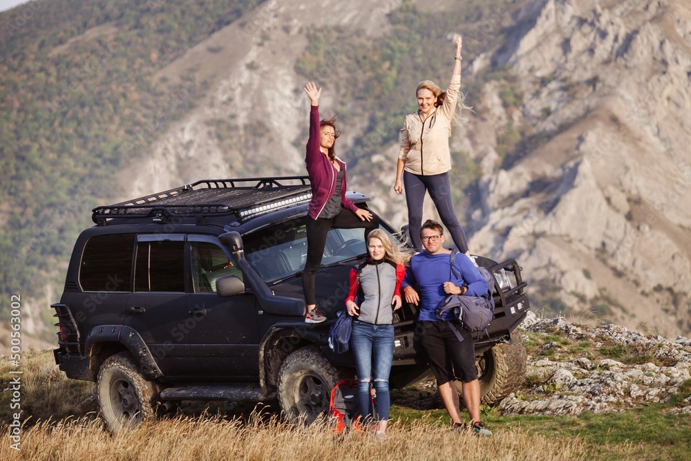 Friends on a hiking trip reaching the summit