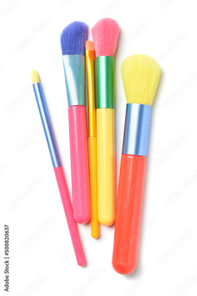 Colorful makeup brushes on white background