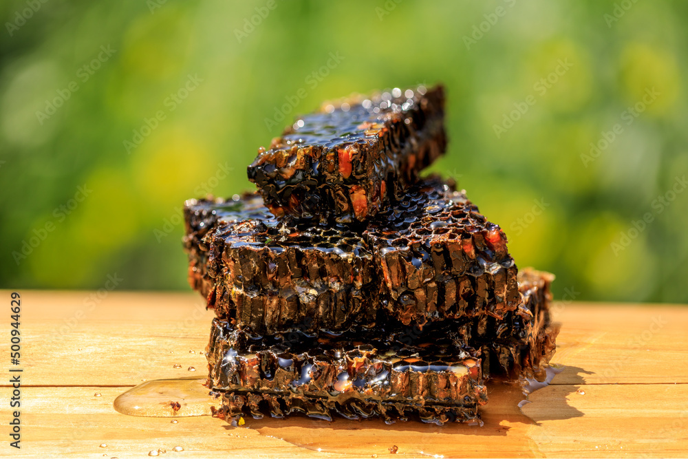 Honeycomb and honey natural ingredients on wooden table